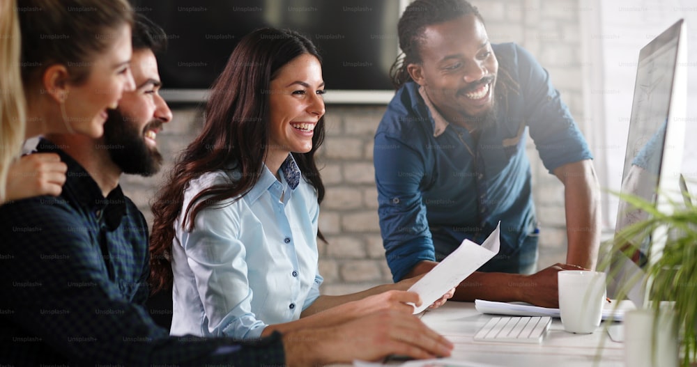 Group of young designers working as team in office