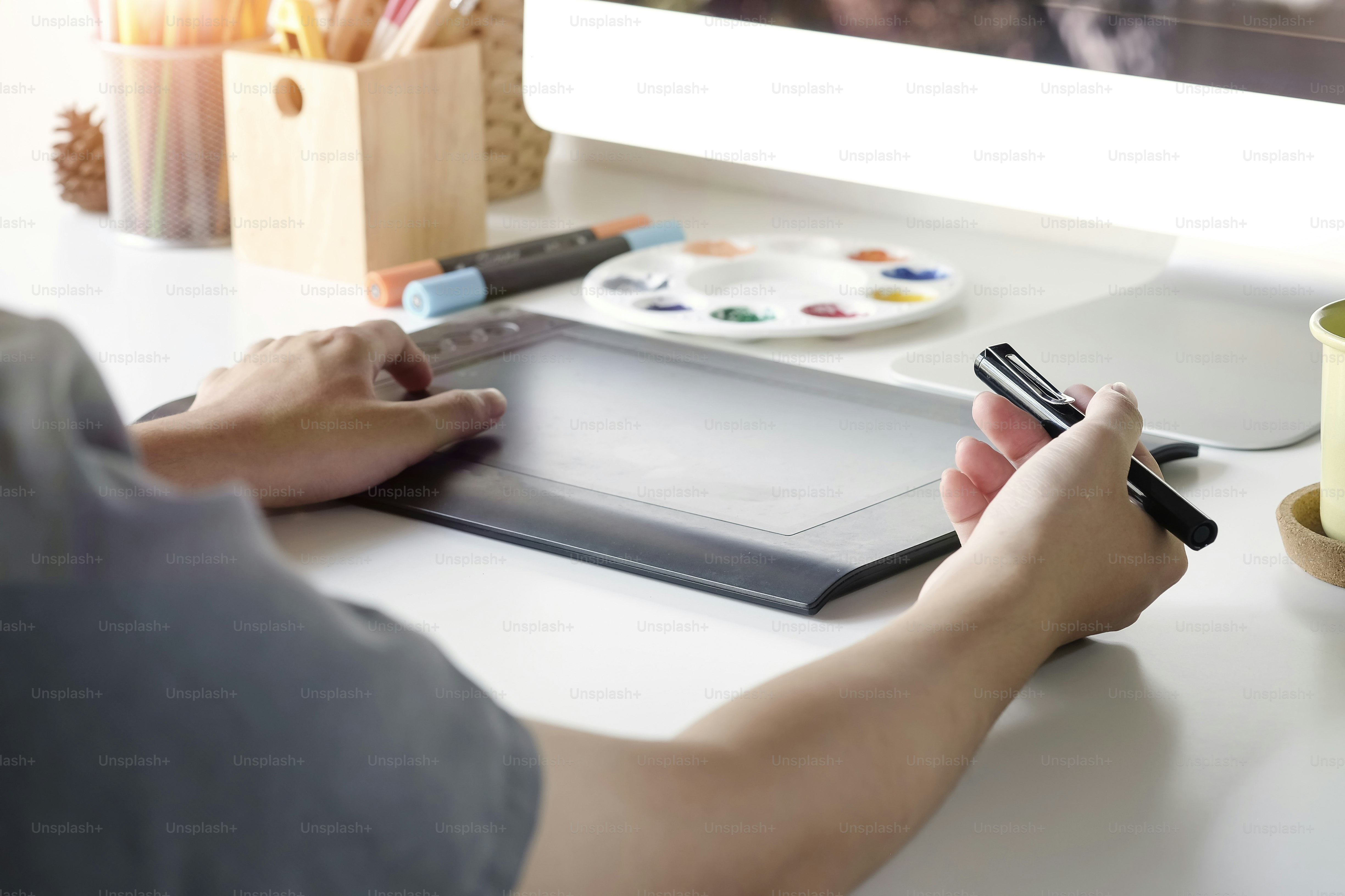 Cropped shot photo of graphic designer artist working with digital tablet and computer.