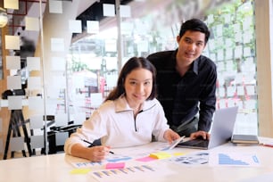 Startup business, Portrait shot of young man and woman working with finance data paper.