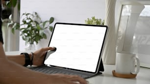 Woman freelancer is working on tablet computer with blank copy space screen for your advertising graphic display