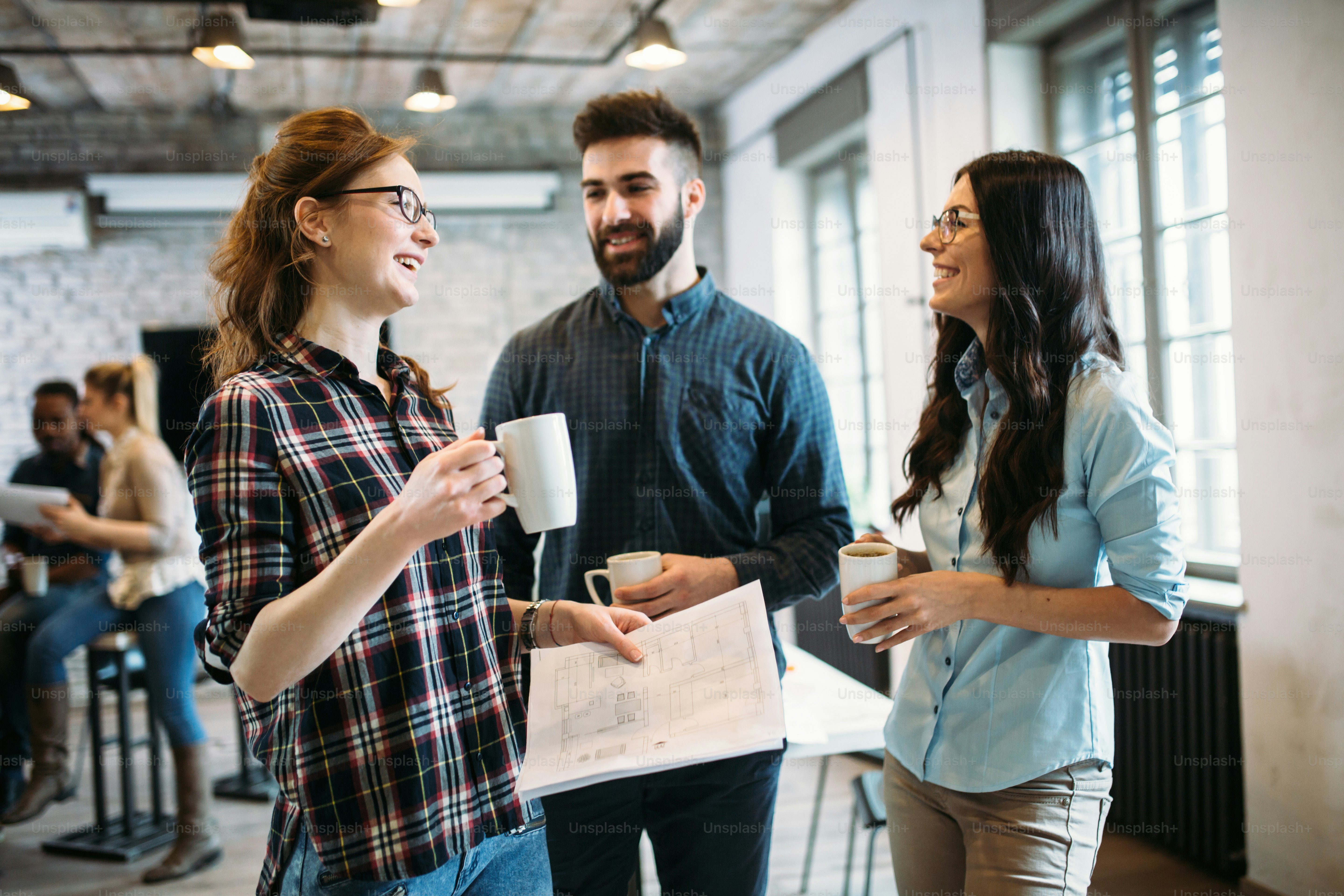 Portrait of young architects having discussion in office