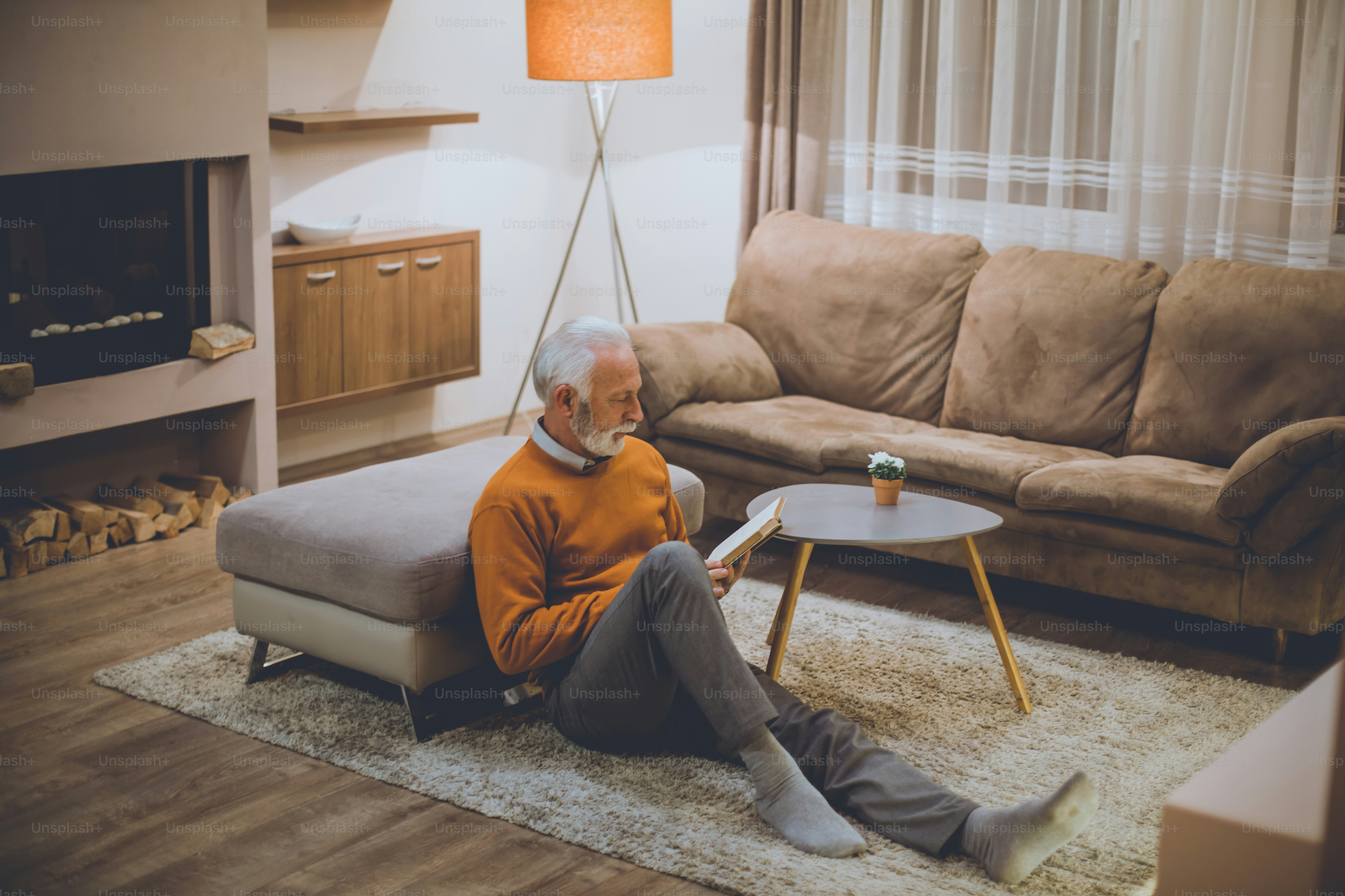 Let your hobby be reading. Senior man reading book at home.