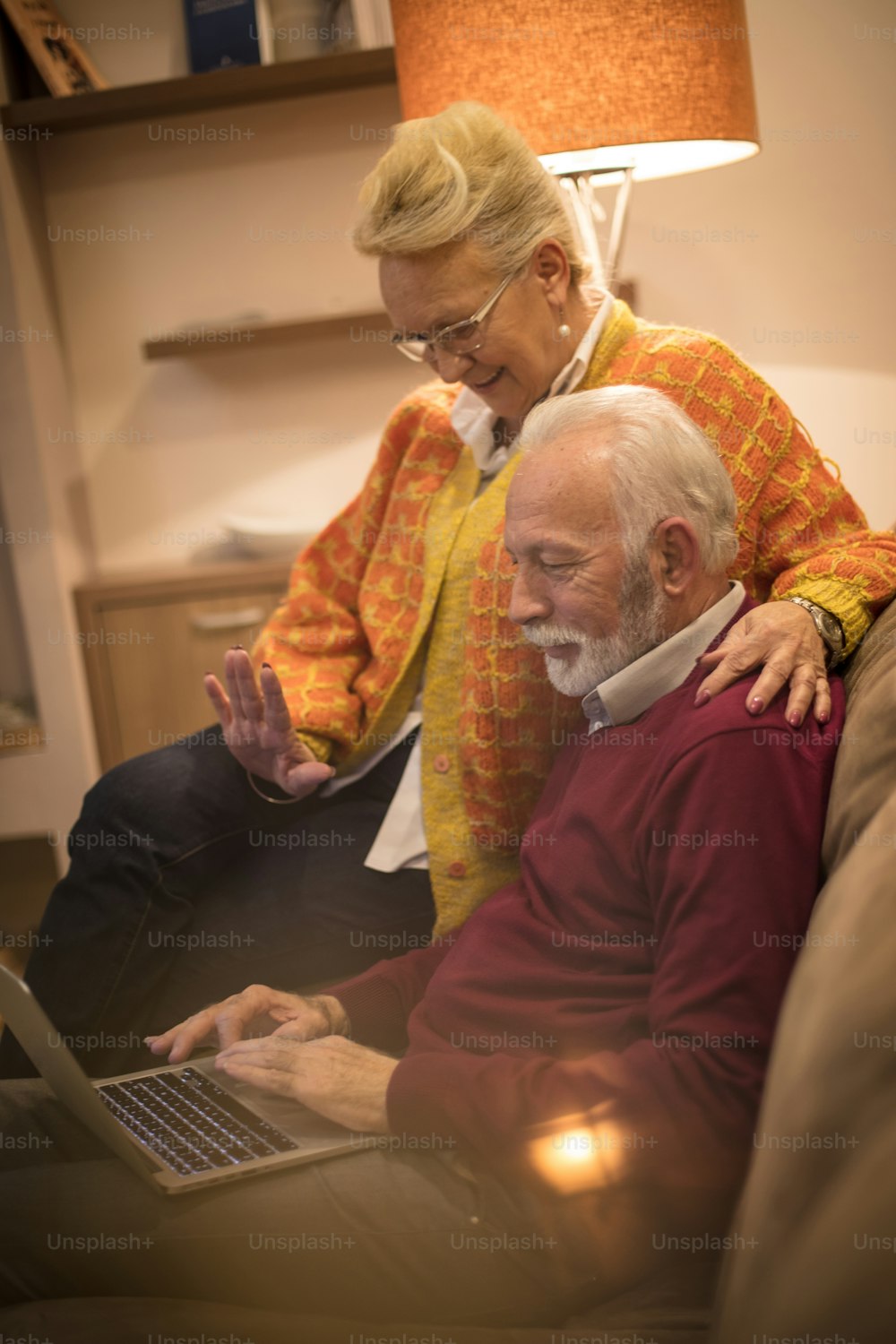 Show me how these works. Senior couple using laptop.
