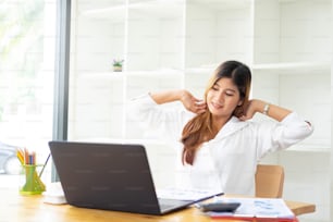 Smiling businesswoman relaxing at chair hands happy asian woman resting in office satisfied after working done.