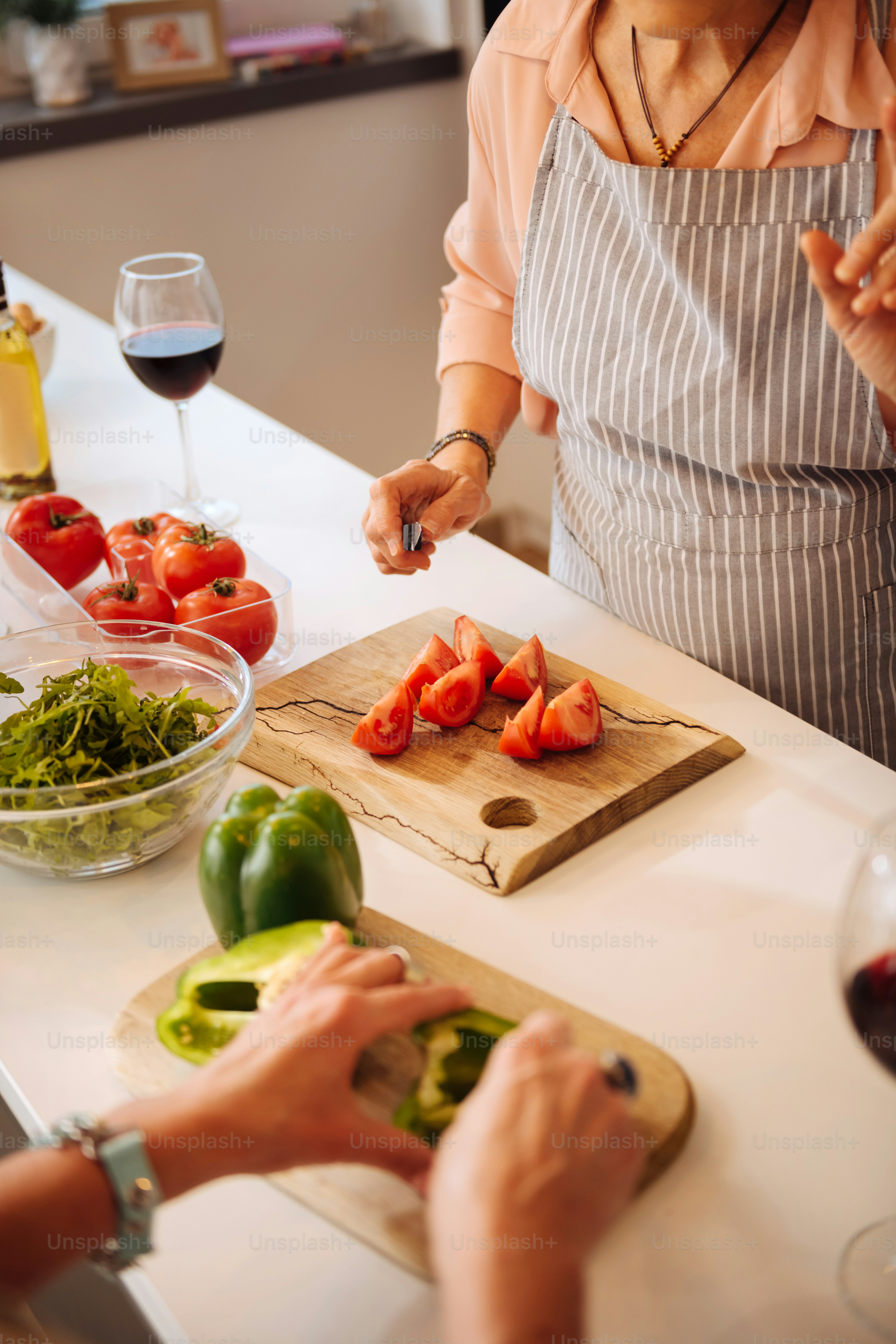 Healthy salad. Top view of a cutting board with tomatoes during salad preparation