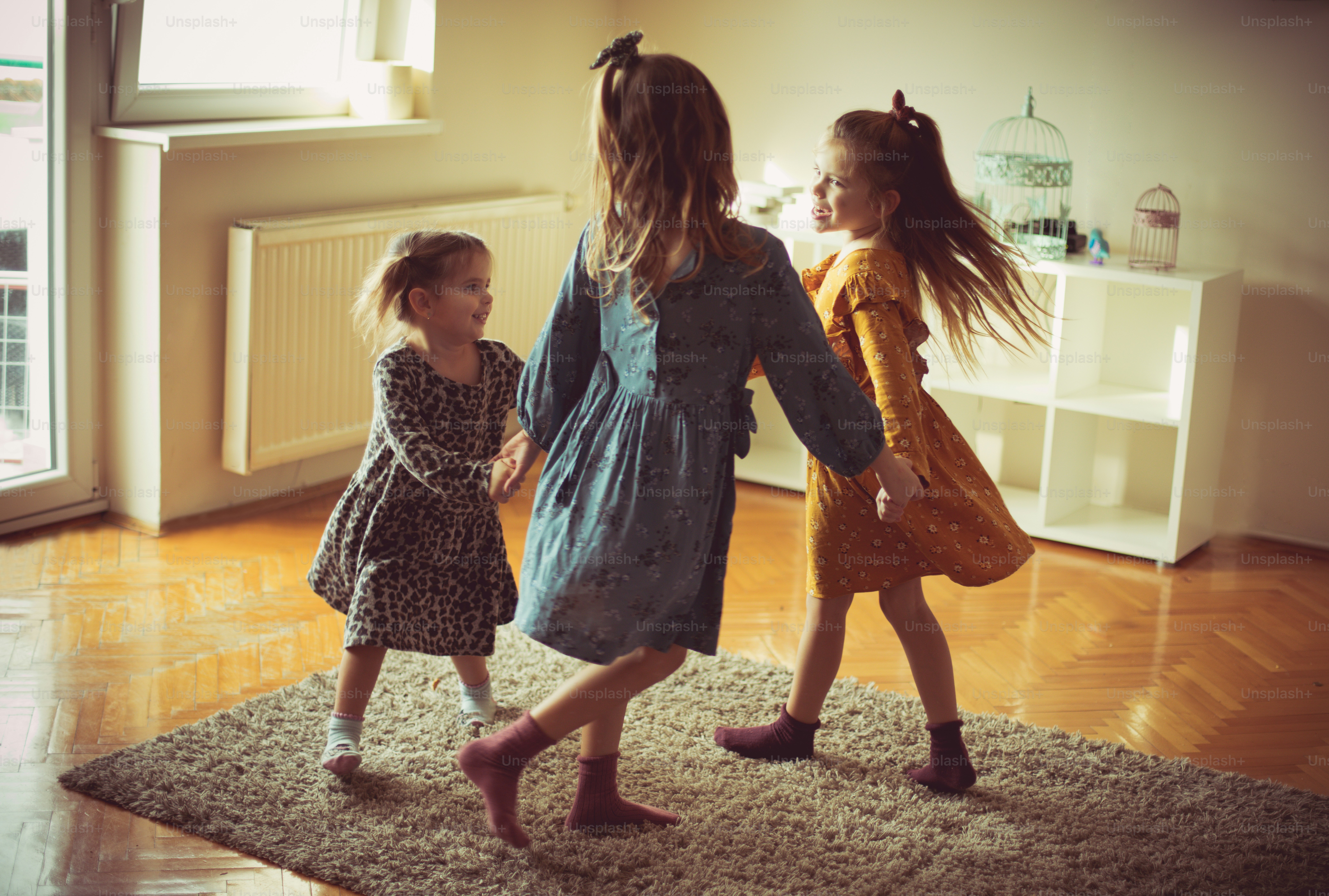 Let's party. Three little girls playing at home.