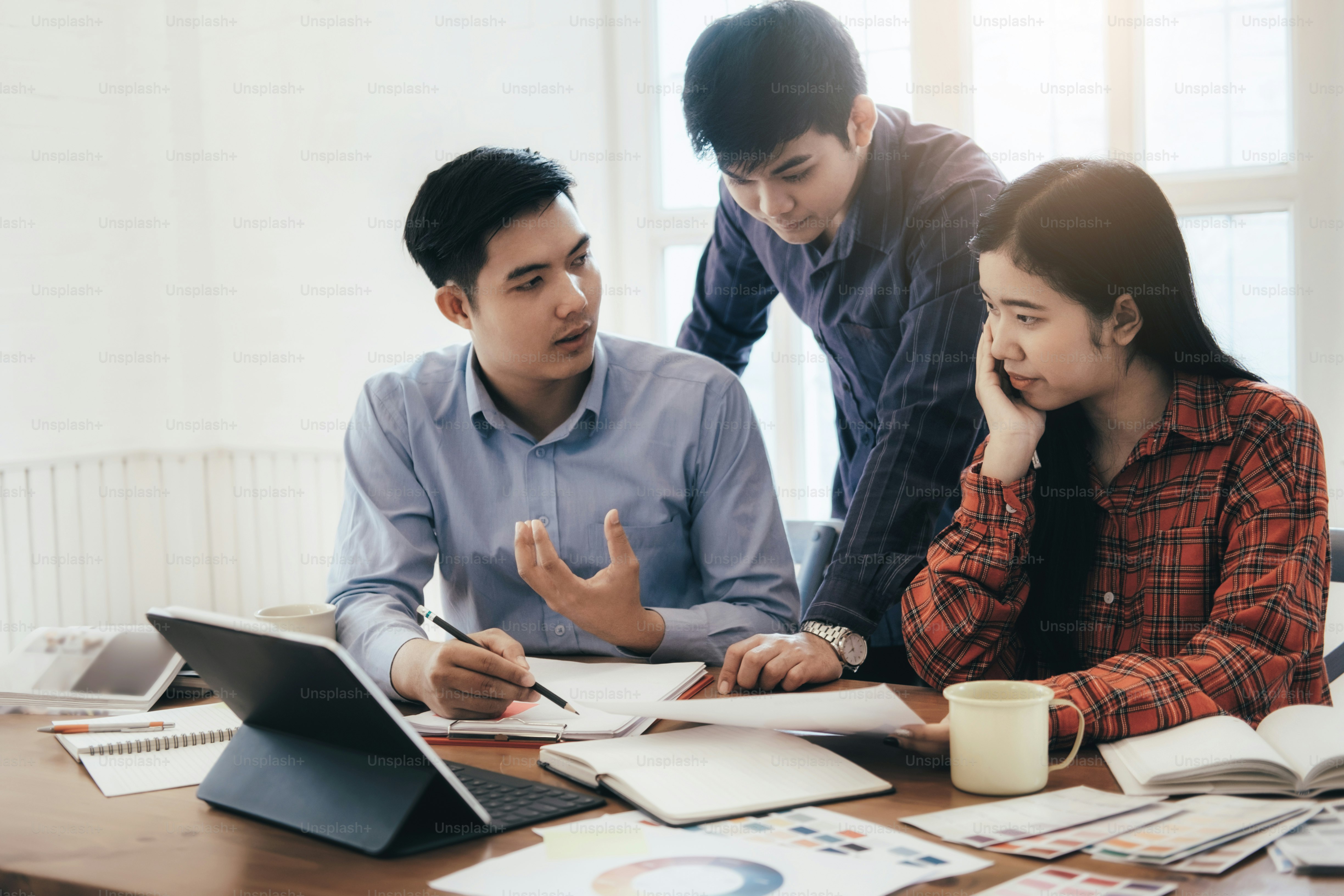 Team of Designer working at office. Brainstorming meeting creative team.