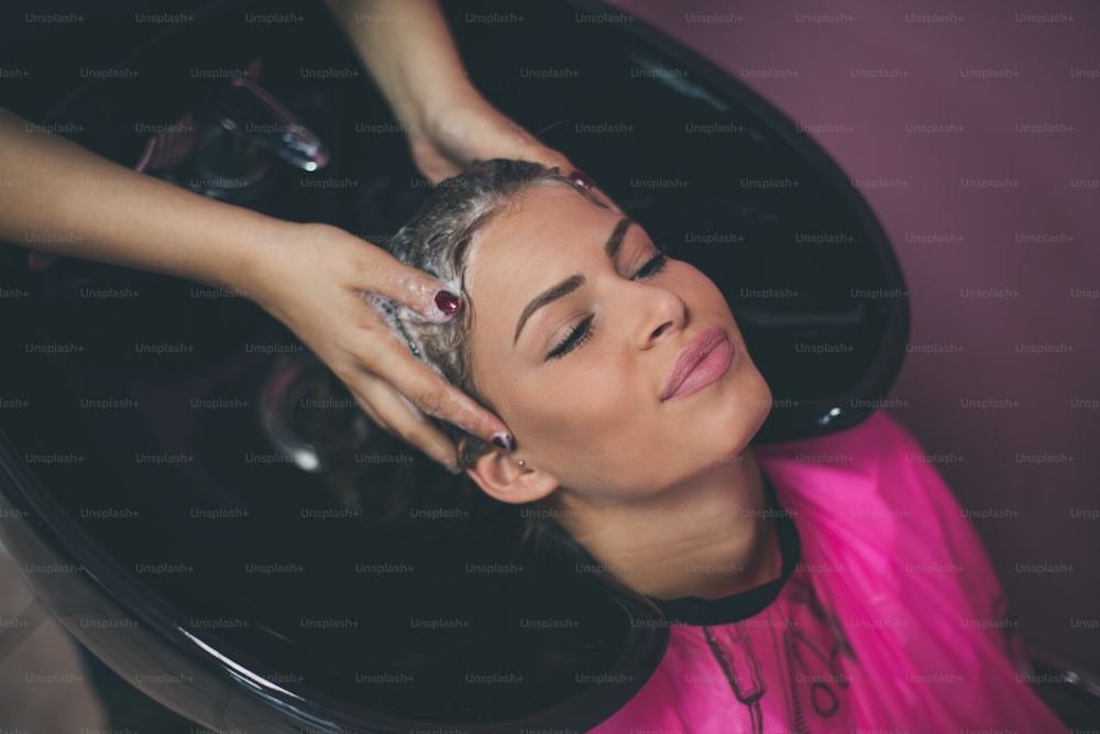 Relax with good hands. Woman at the hairdresser. Close up.