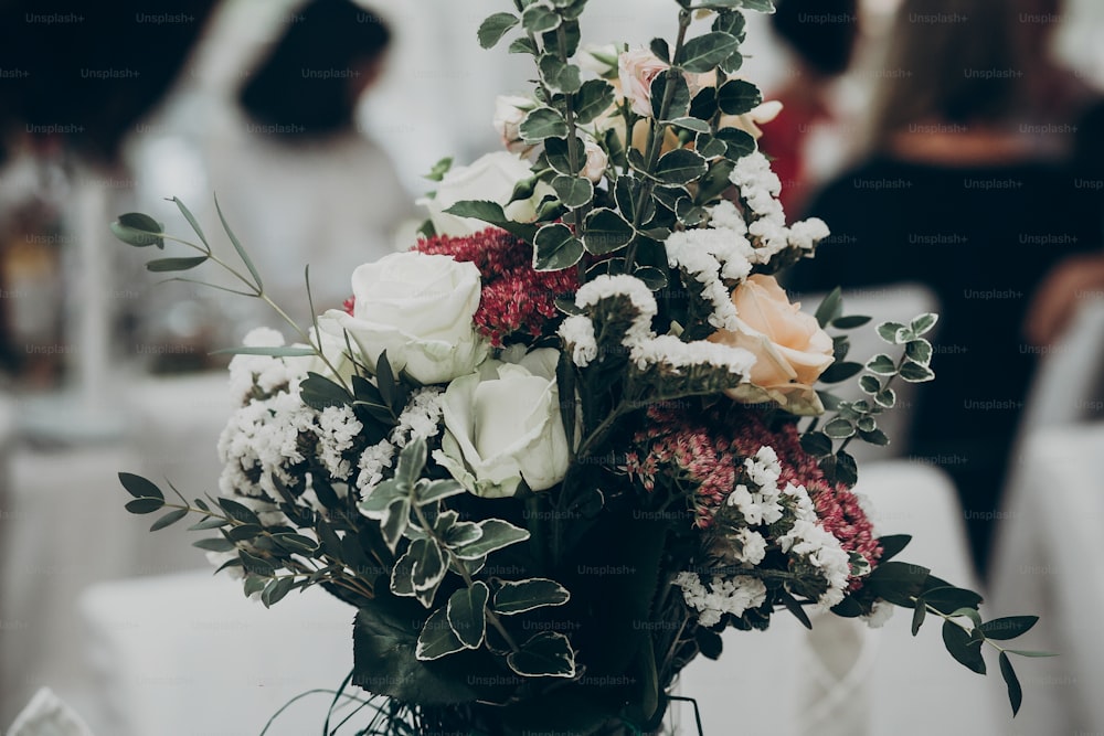 stylish rustic bouquet on table at wedding reception. space for text. floral arrangements and decor. luxury life and wedding reception. expensive catering