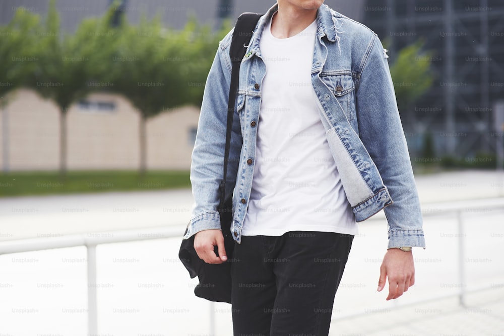 Young boy in a blue denim jacket on the street