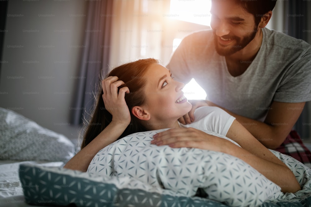 Couple and lovely moments in the bed - Close up of boyfriend giving massage for his beautiful girlfriend relaxing in a bed