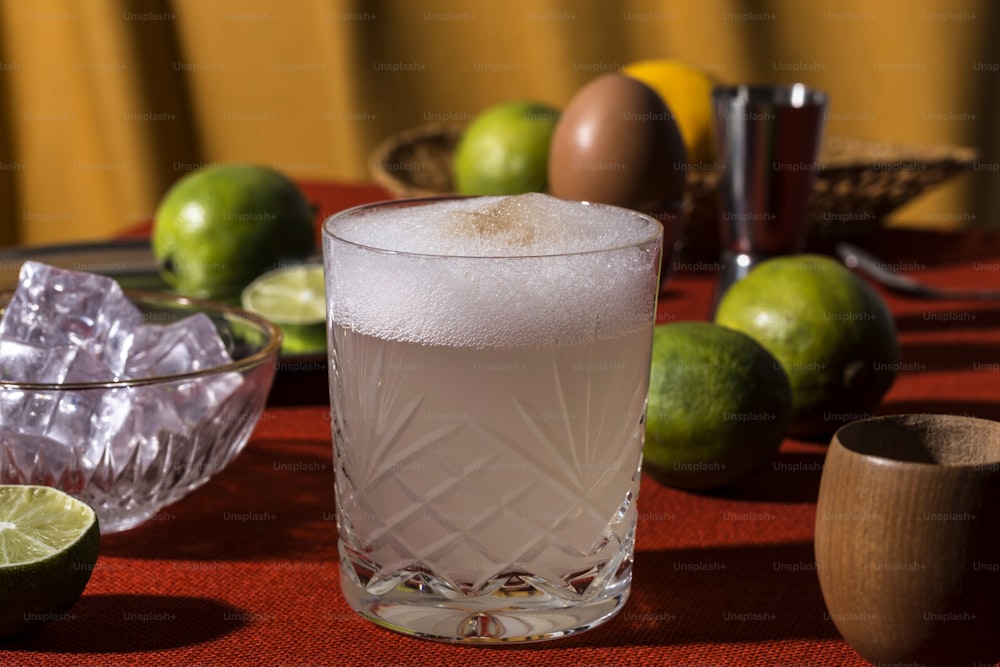 A pisco sour is an alcoholic cocktail of Peruvian origin that is typical of the cuisines from Chile and Peru. The drink's name comes from pisco, which is its base liquor, and the cocktail term sour, in reference to sour citrus juice and sweetener components. The Peruvian pisco sour uses Peruvian pisco as the base liquor and adds freshly squeezed lime juice, simple syrup, ice, egg white, and Angostura bitters. The Chilean version is similar, but uses Chilean pisco and pica lime, and excludes the bitters and egg white.