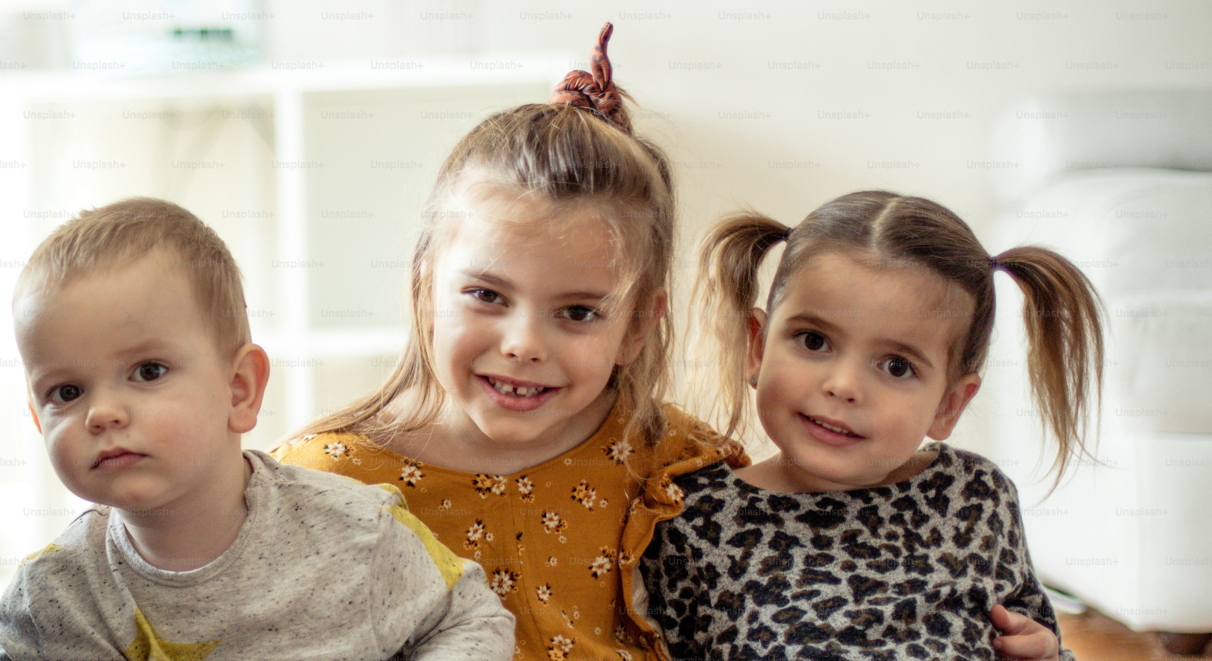 Boding. Three little children at home together.