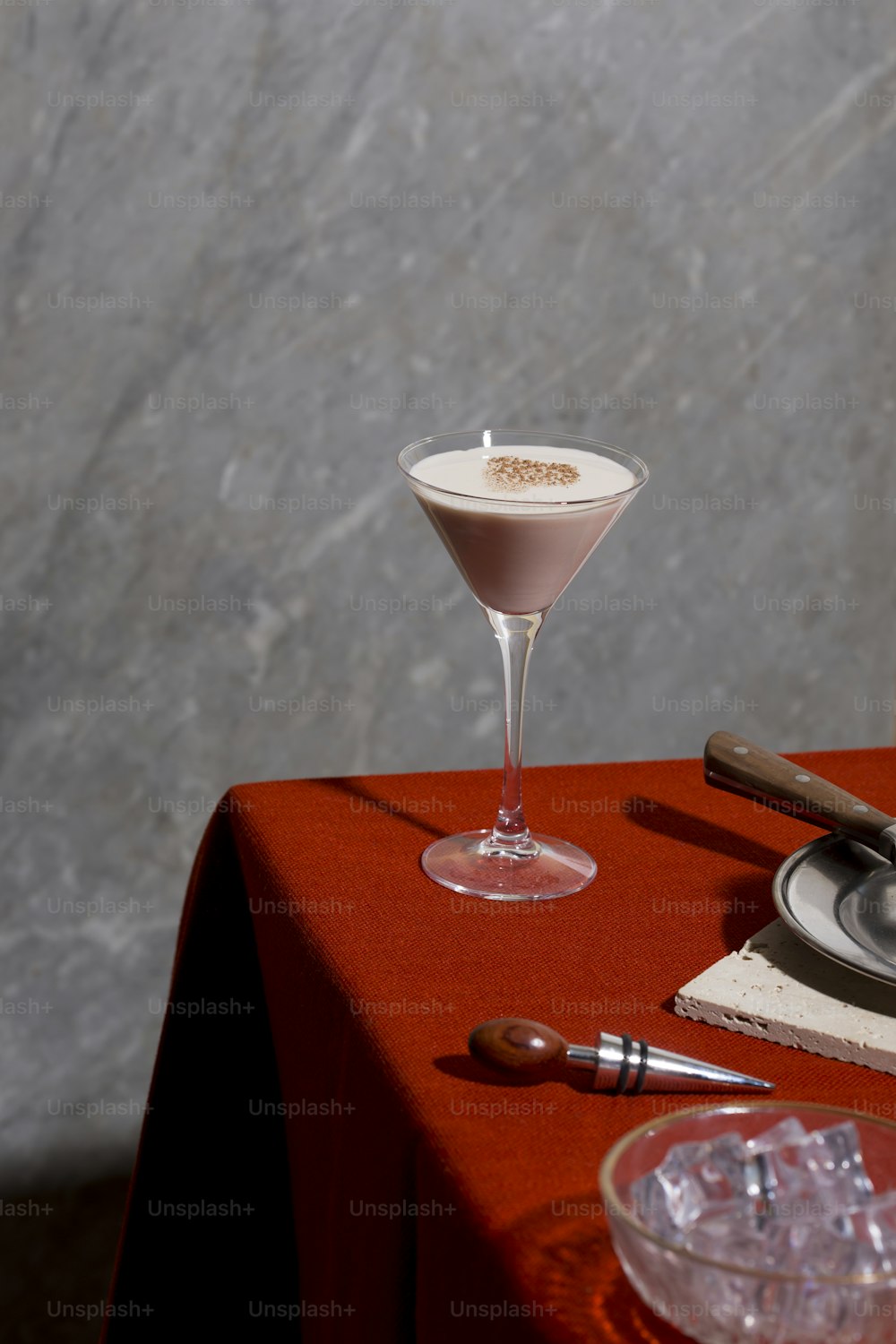With gin or cognac, white creme de cacao, fresh cream (half and half) and  grated nutmeg