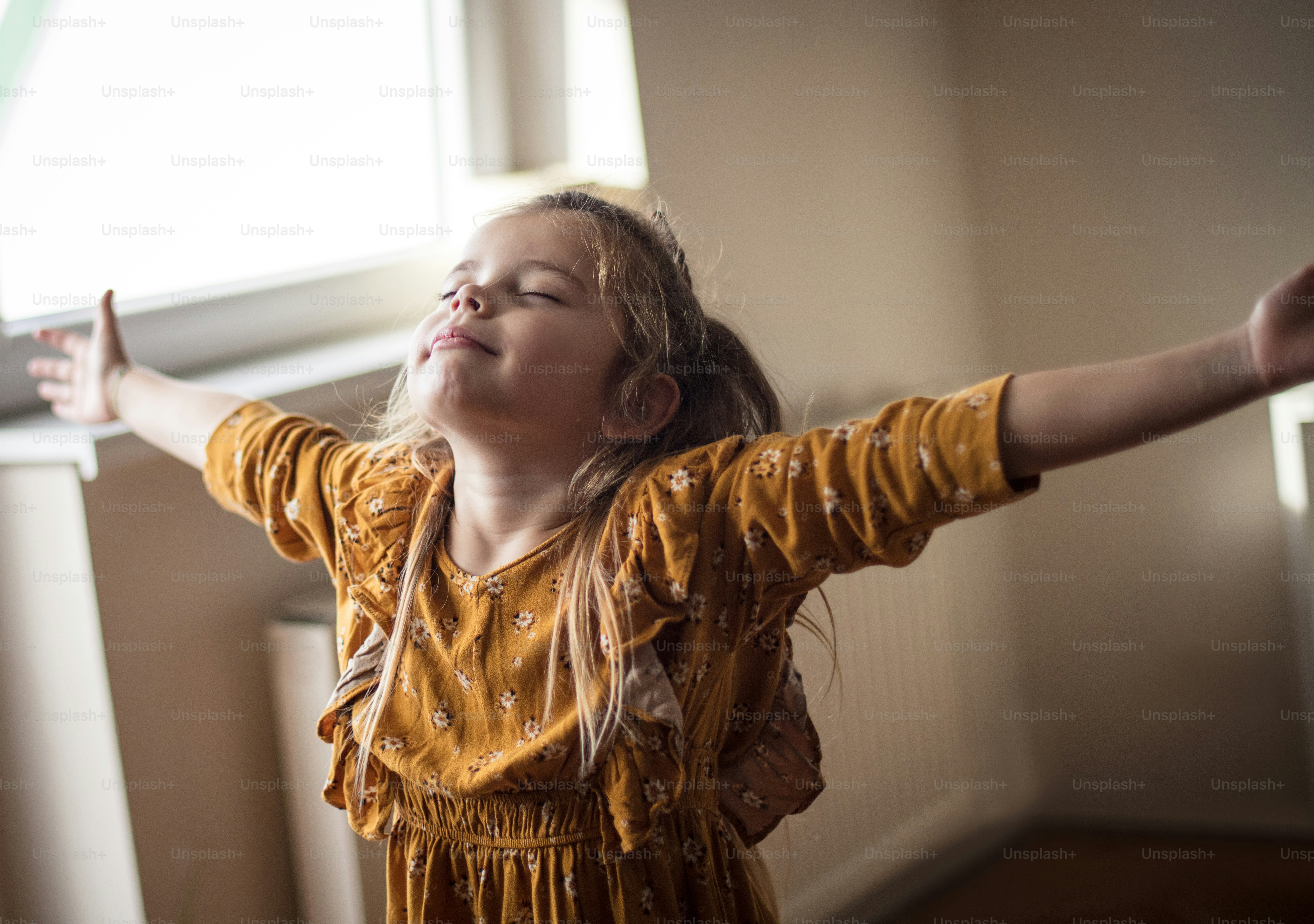 Joyful childhood moment. Little girl at home.