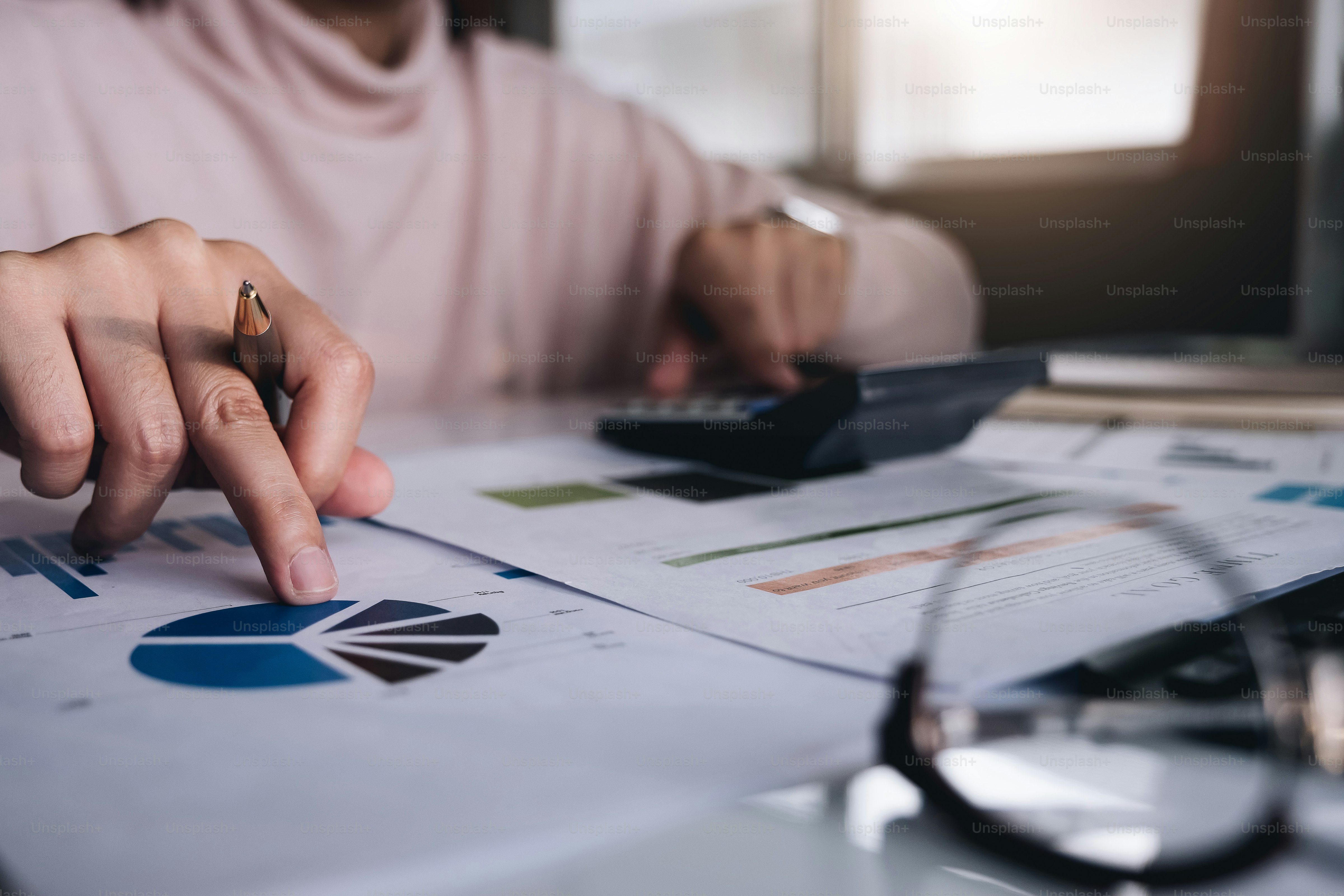 Businessman using calculator for calculating finance, tax, accounting, statistics and analytic research concept