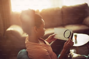 Which amount of money is in question? African American woman checking the Blanco Check. Close up.