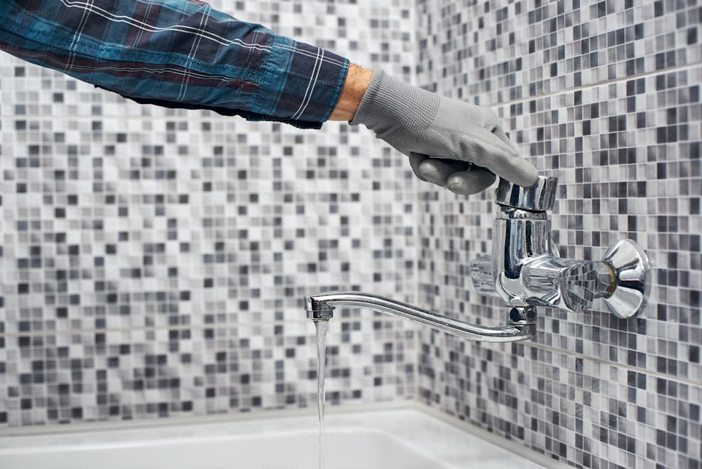 All will be perfect. Man open fauset in bathroom sink. Closeup on hand open faucet of a sink.