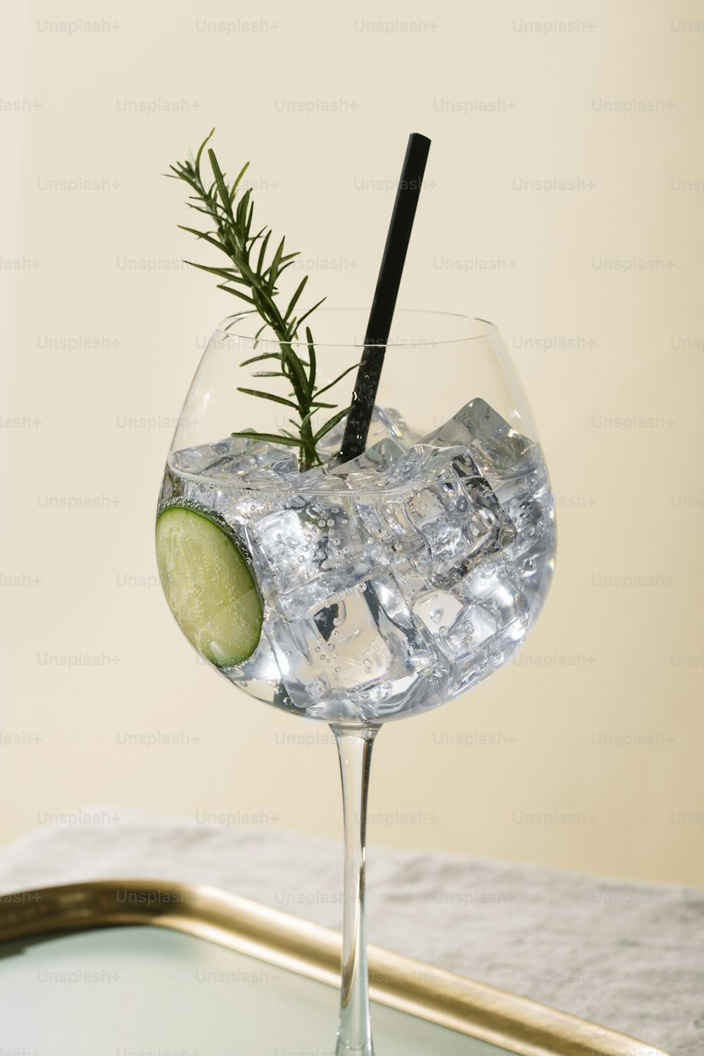 Gin tonic, an international aperitif cocktail garnished with cucumber and rosemary
