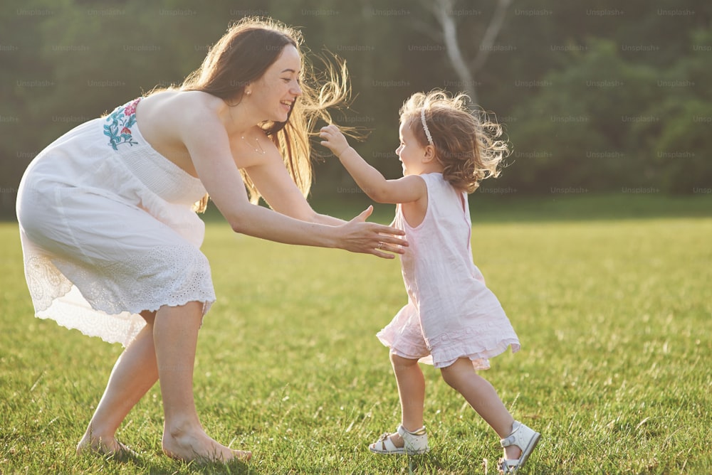 Happy family, active mother with little child, adorable toddler girl.