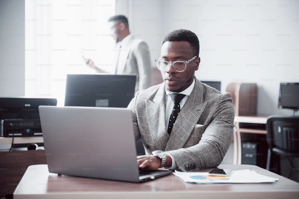 Two handsome cheerful african american executive business man at the workspace office.