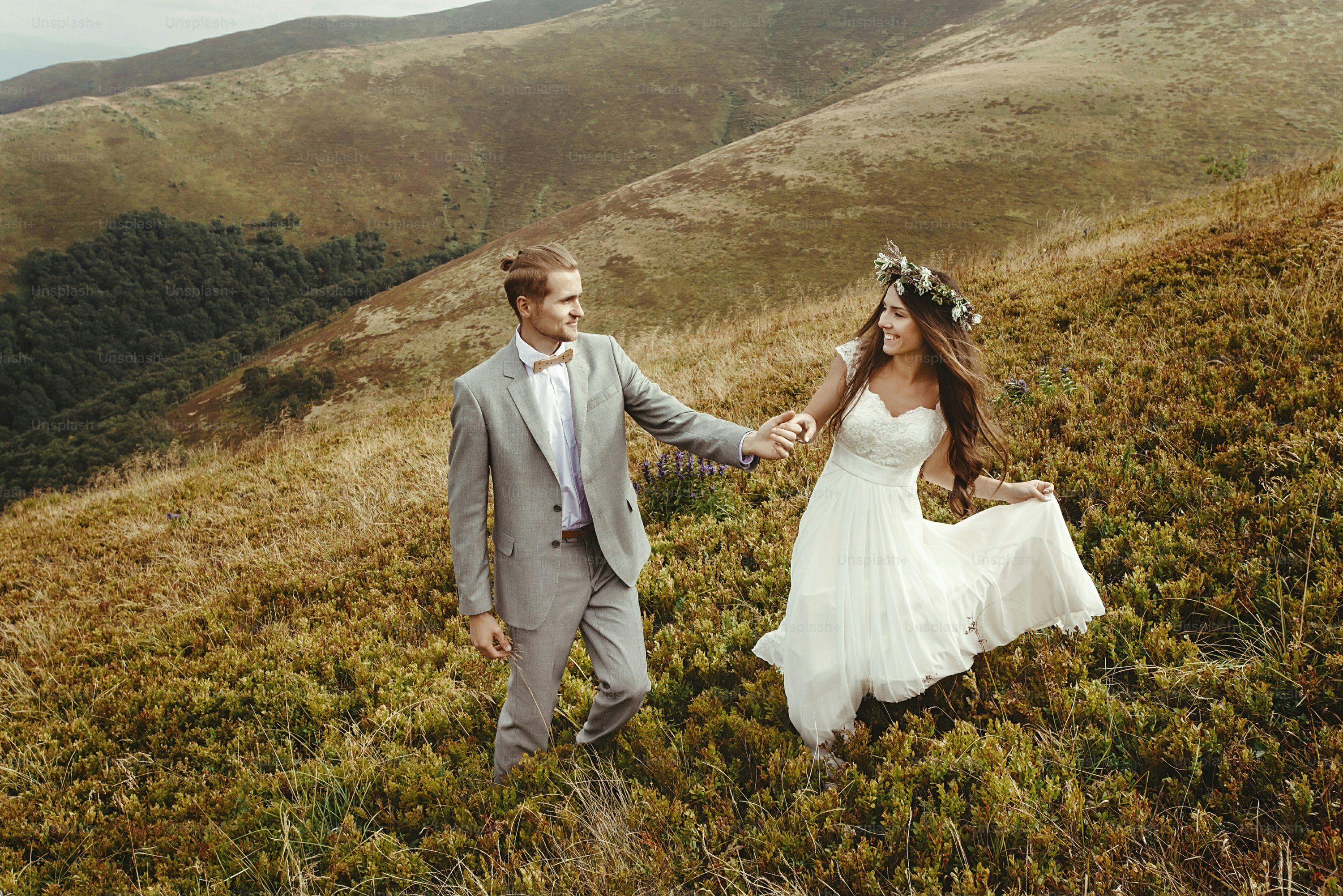 happy gorgeous bride and groom walking  in sun light holding hands and smiling, perfect moment, boho wedding couple