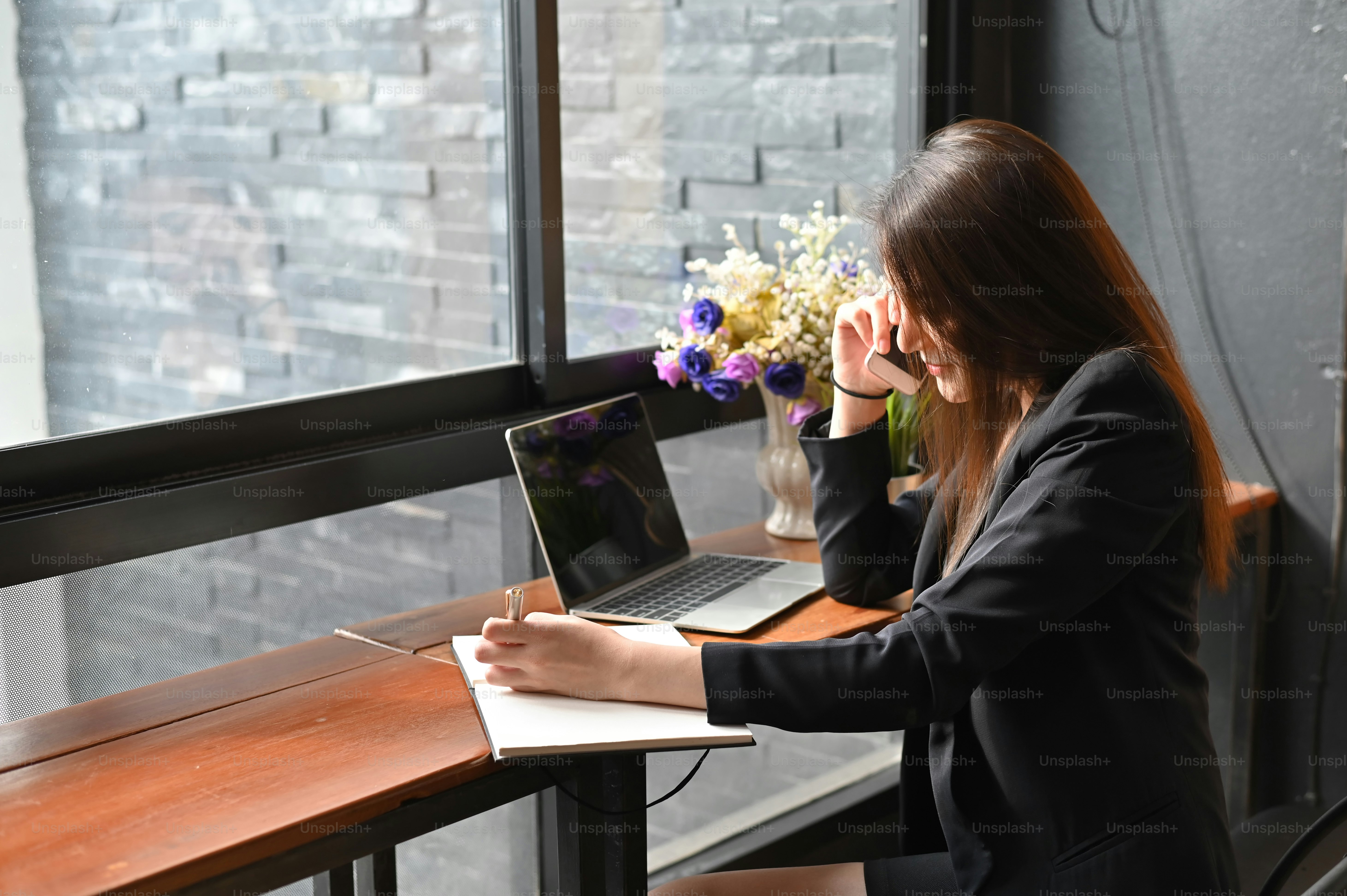 Secretary women calling with mobile phone in business office.