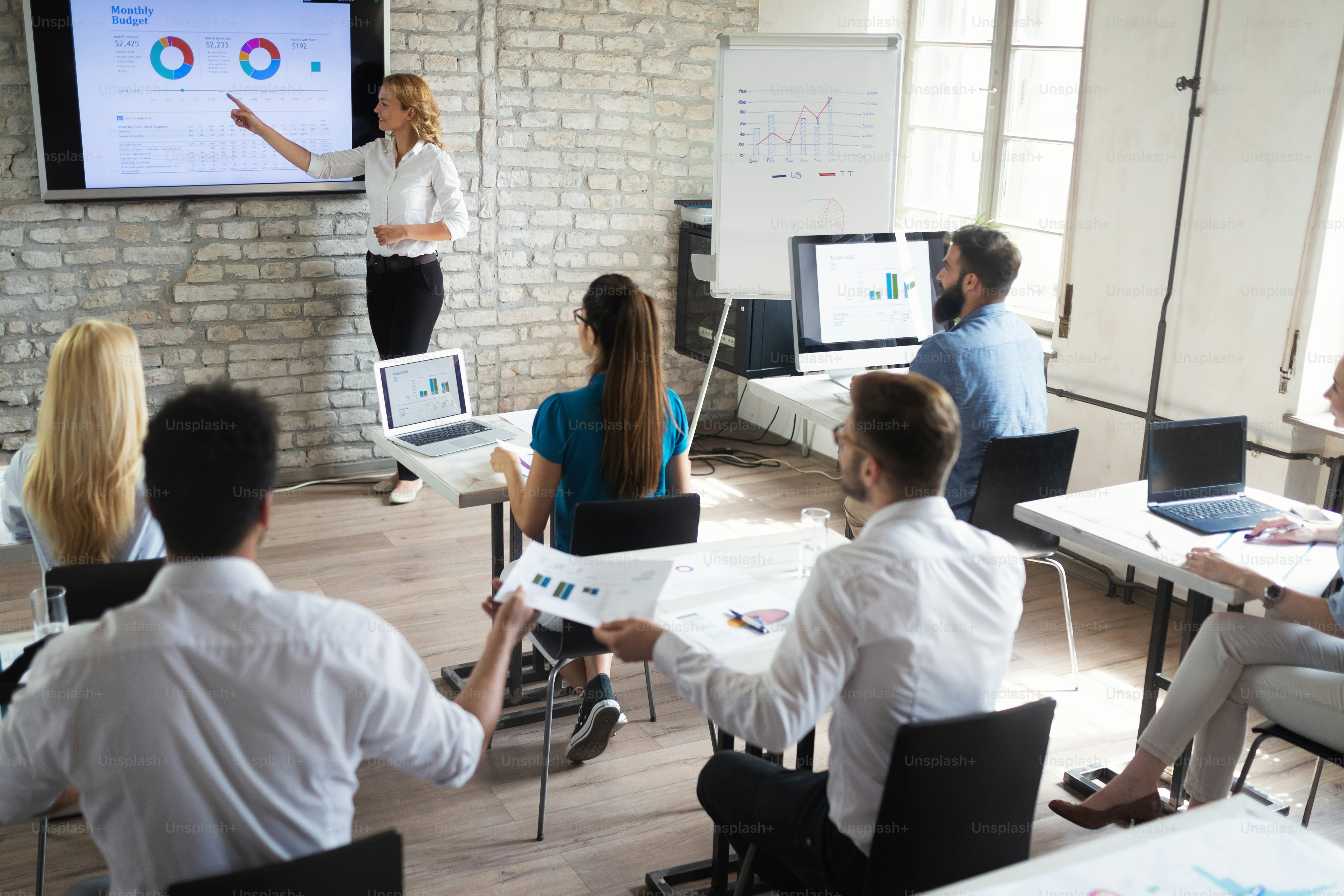 Successful happy group of students learning software engineering and business during presentation