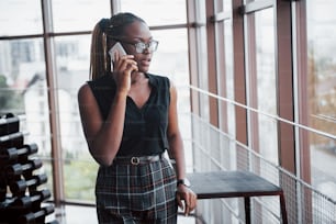 An American business woman speaks on her cellphone in the office