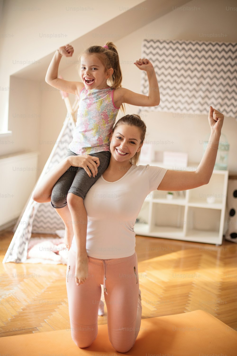 We are strong together. Mother and daughter working exercise.