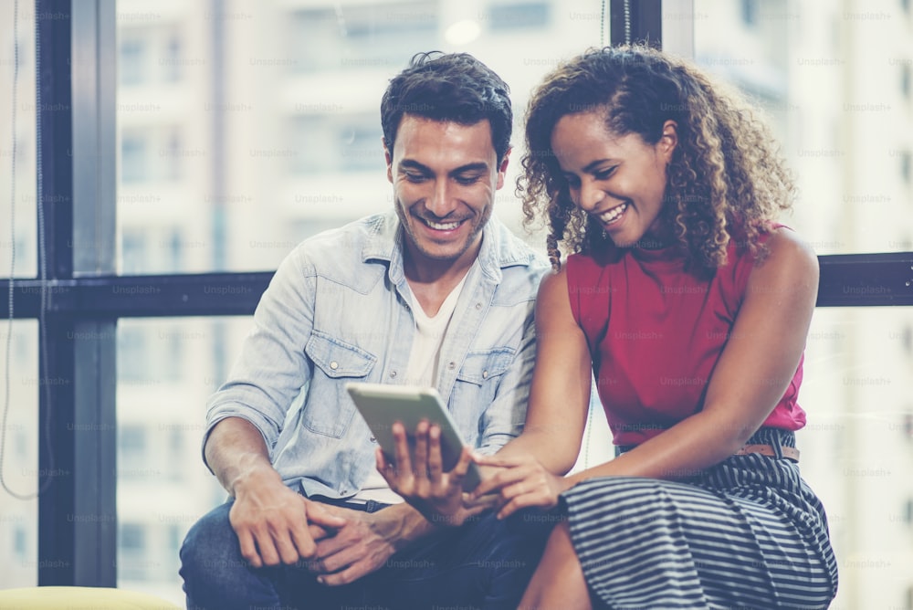 Businesswoman and businessman looking at tablet together