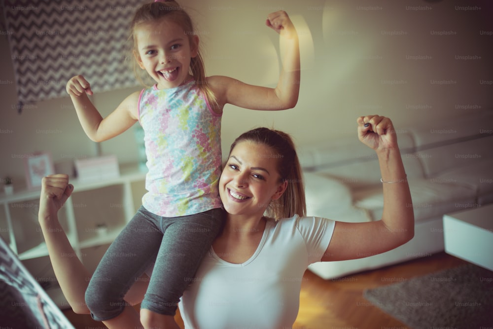 Happy and strong. Mother and daughter working exercise.