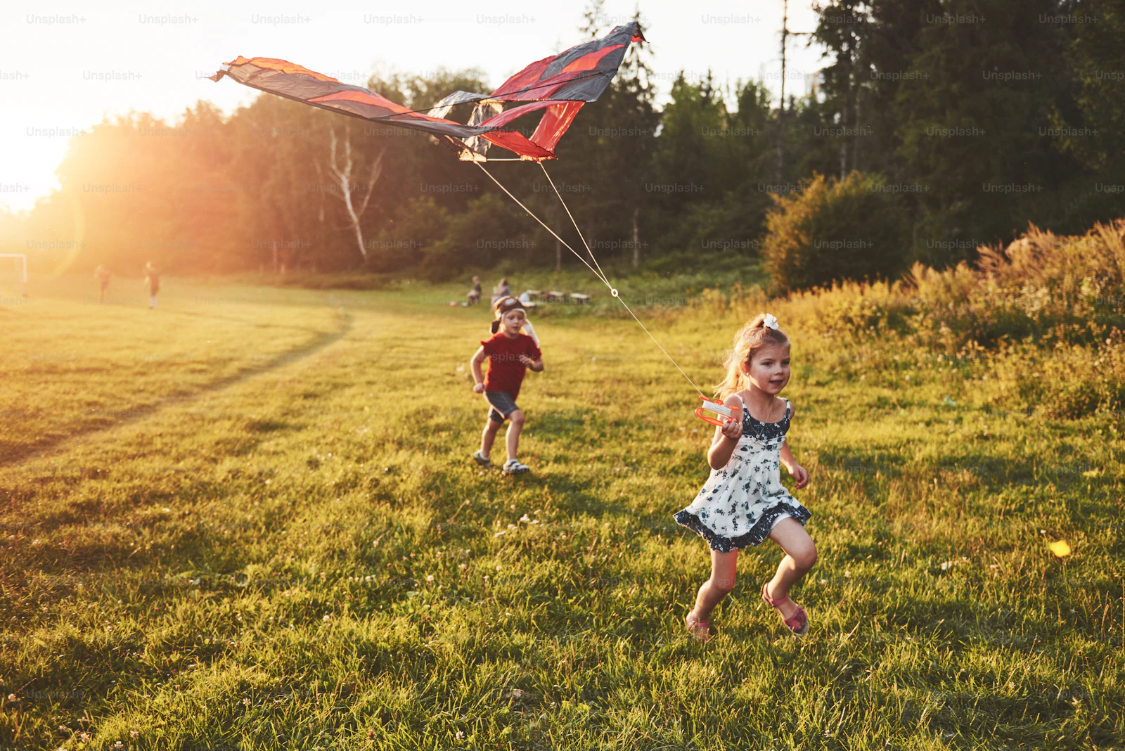 Children playing outdoors in warm sunset light