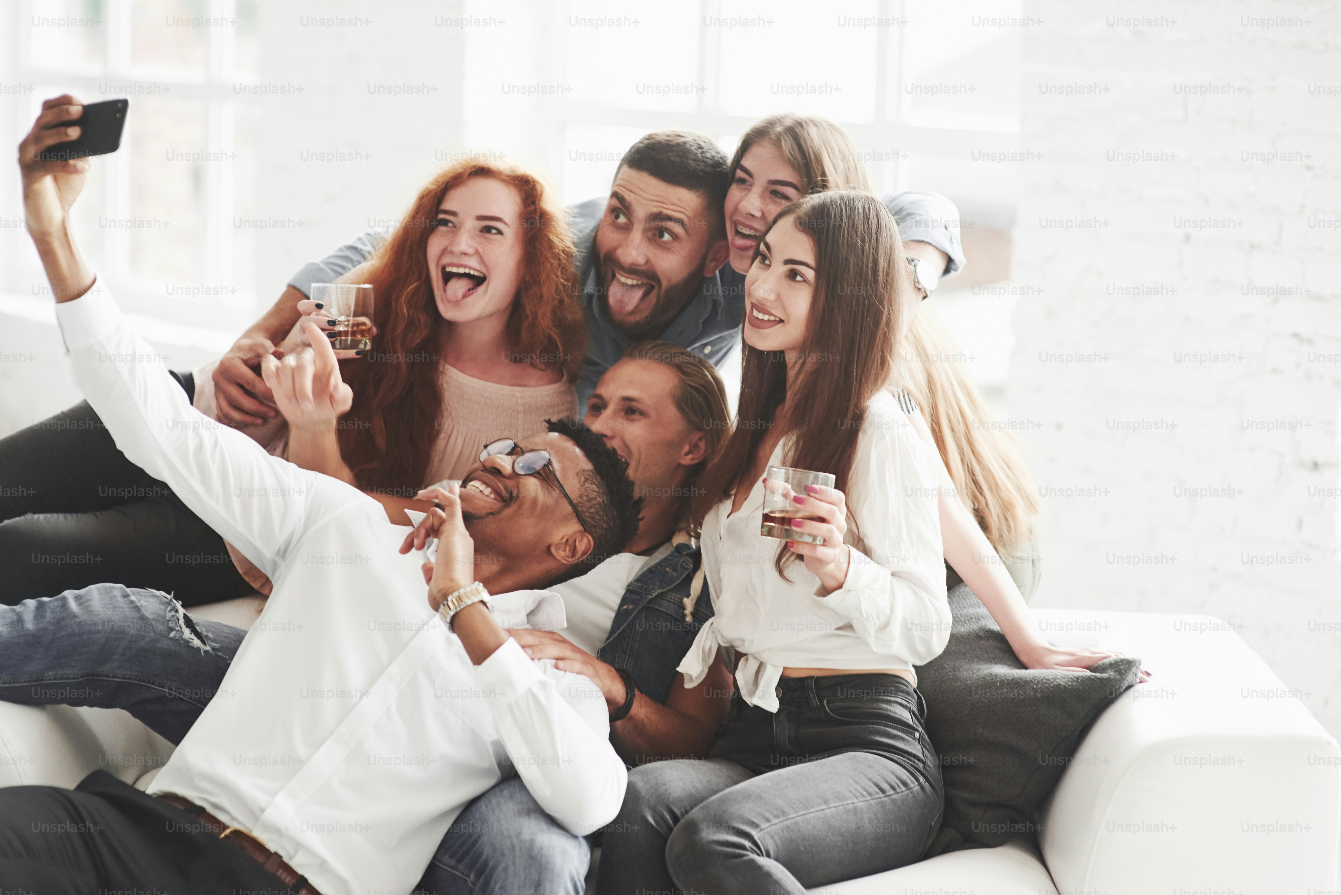 Happy faces. Group of multiracial teammates having good time on their break and taking some photos.