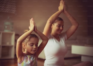 Peace and calm. Mother and daughter working yoga.