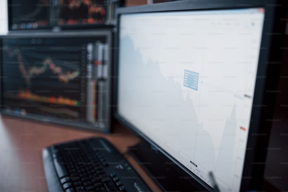 Analyzing data. Close-up of young businessman pointing on the data presented in the chart with pen while working in creative office.