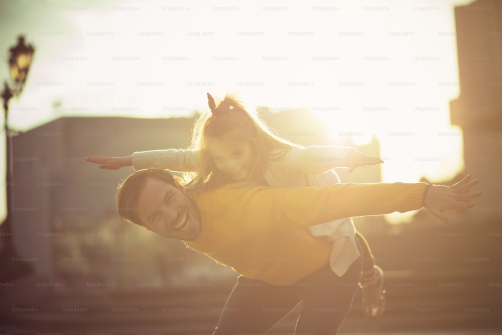 Airplane. Father and daughter playing in the city street.