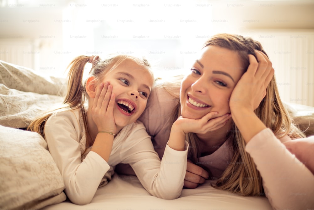 My daughter is my support.  Mother looking in camera while her daughter enjoying in her.