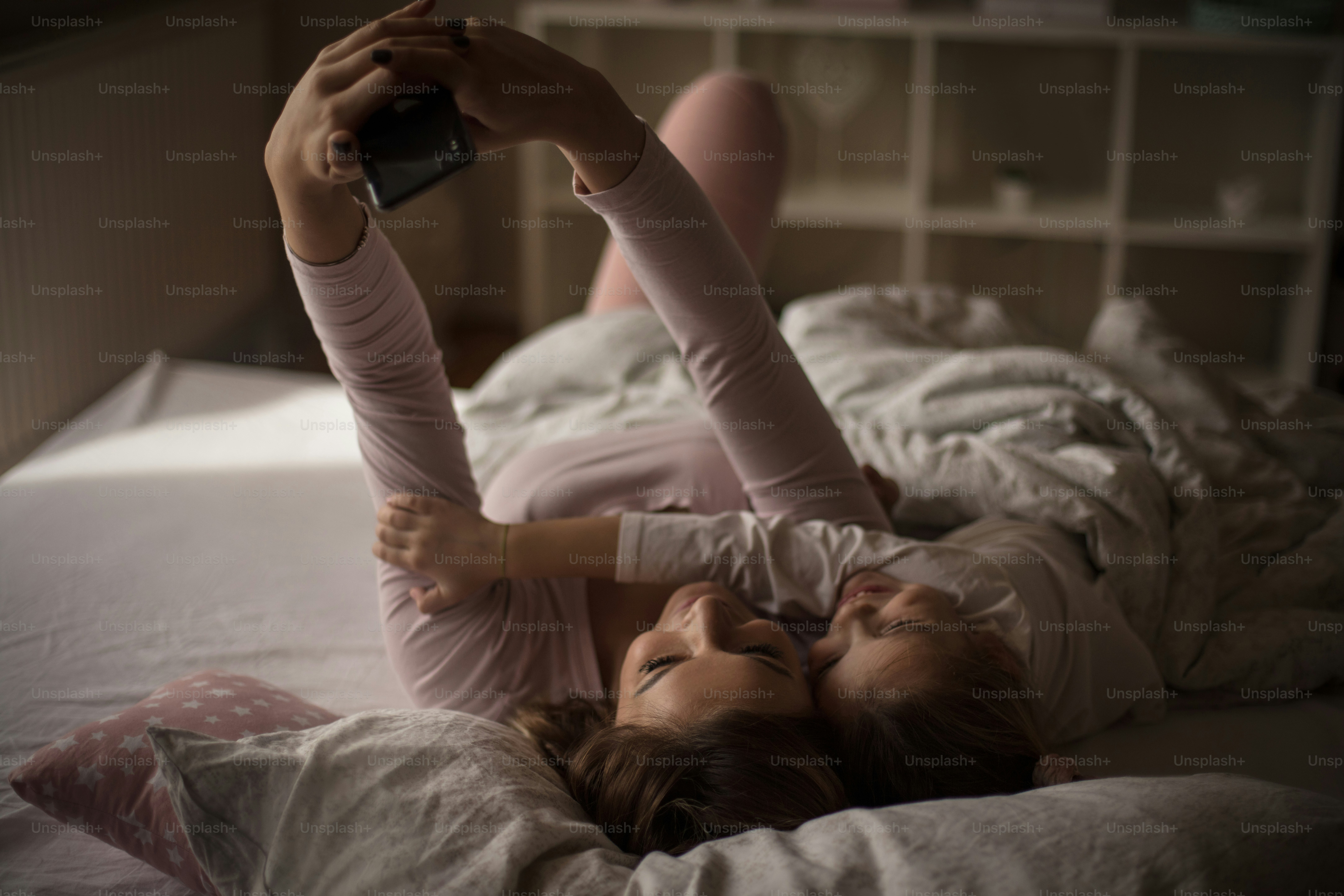 Picture from the bed. Mother daughter in bed.