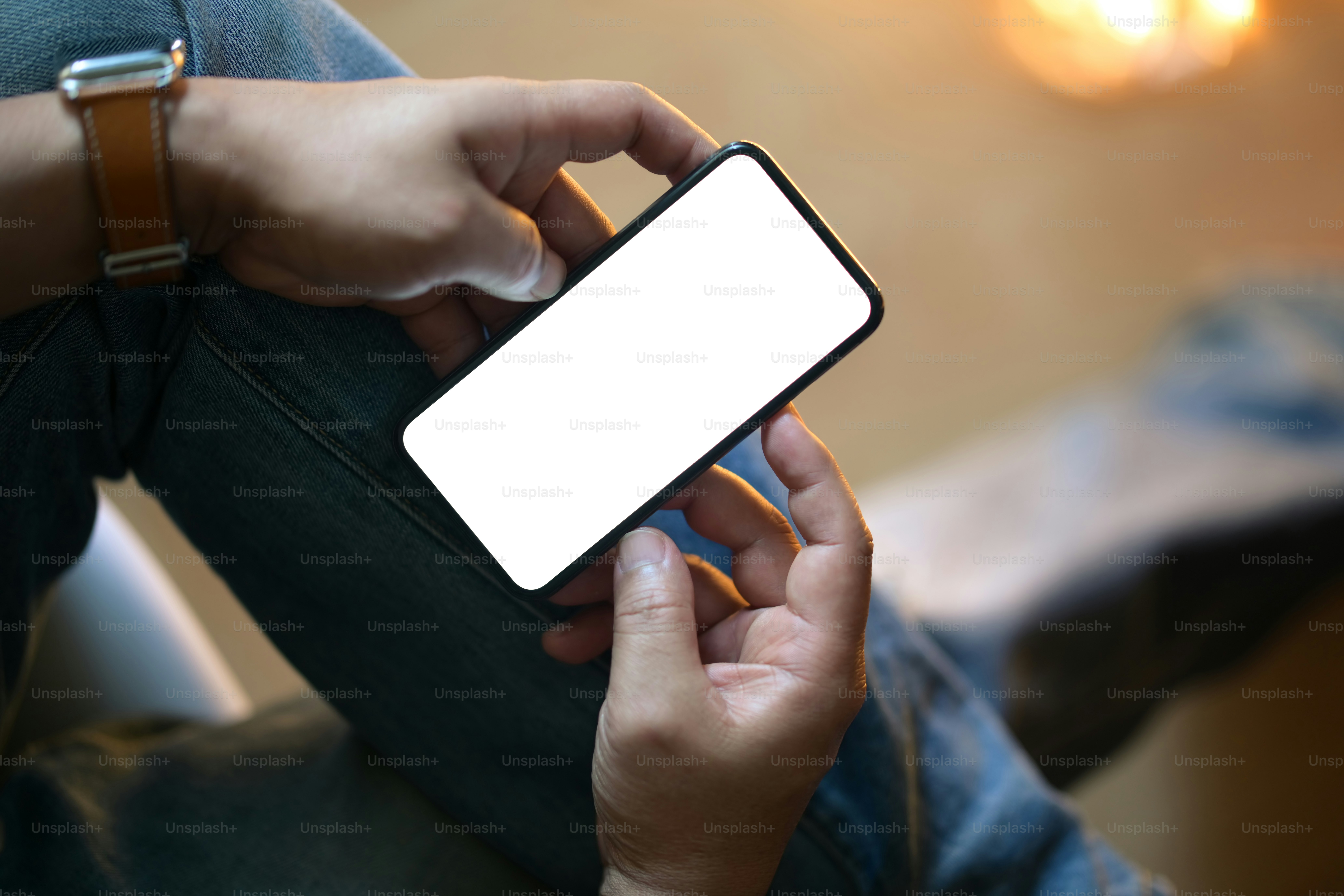 Closeup male hands using mobile smartphone at blurred night background.
