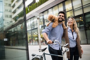 Beautiful romantic couple is having rest in the city with dog and bicycles