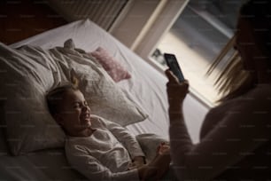 Mother and daughter in bed.