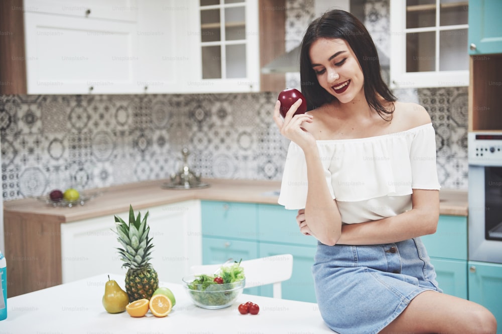 Beautiful woman with healthy food fruit in the kitchen