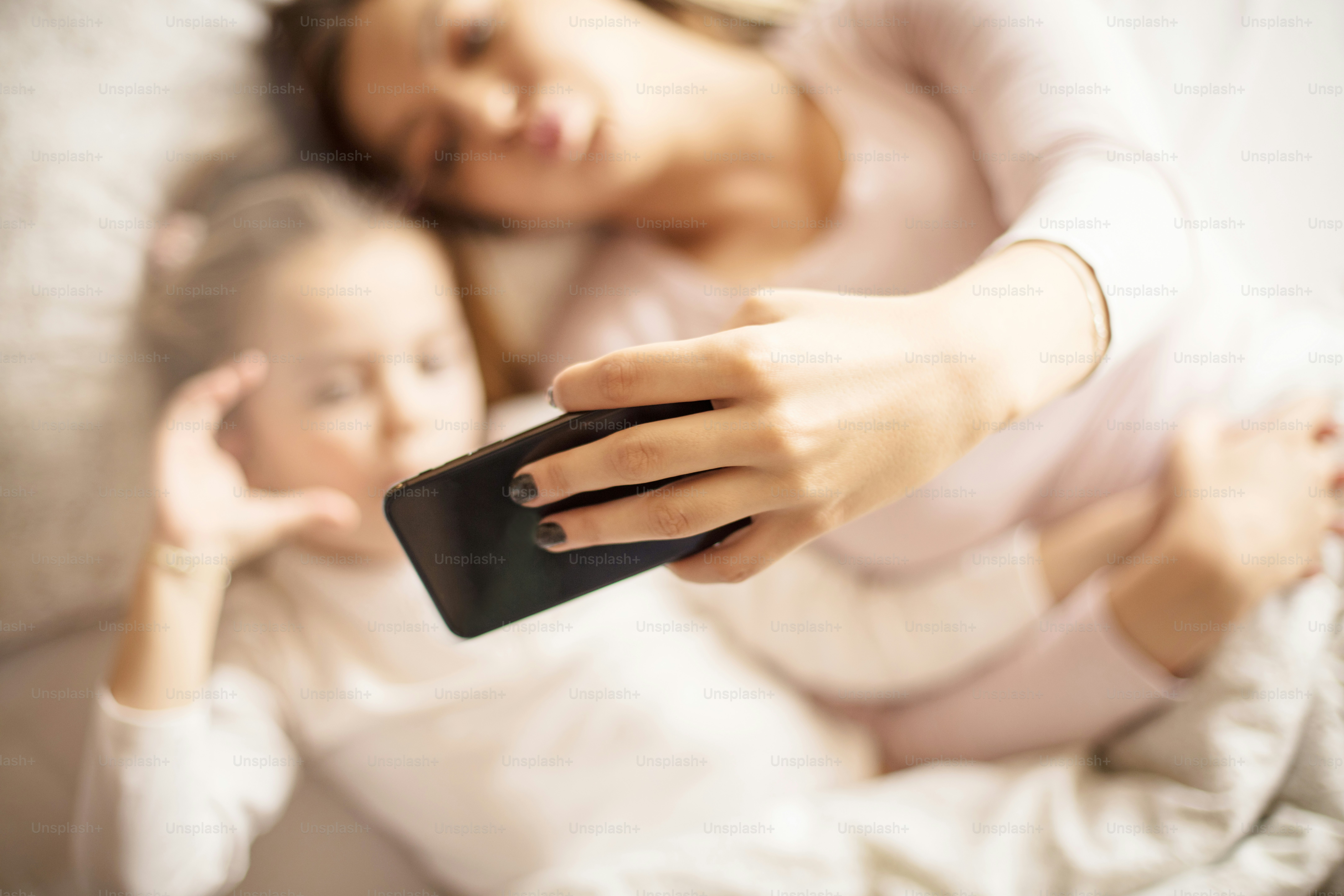 Smile! Mother daughter in bed