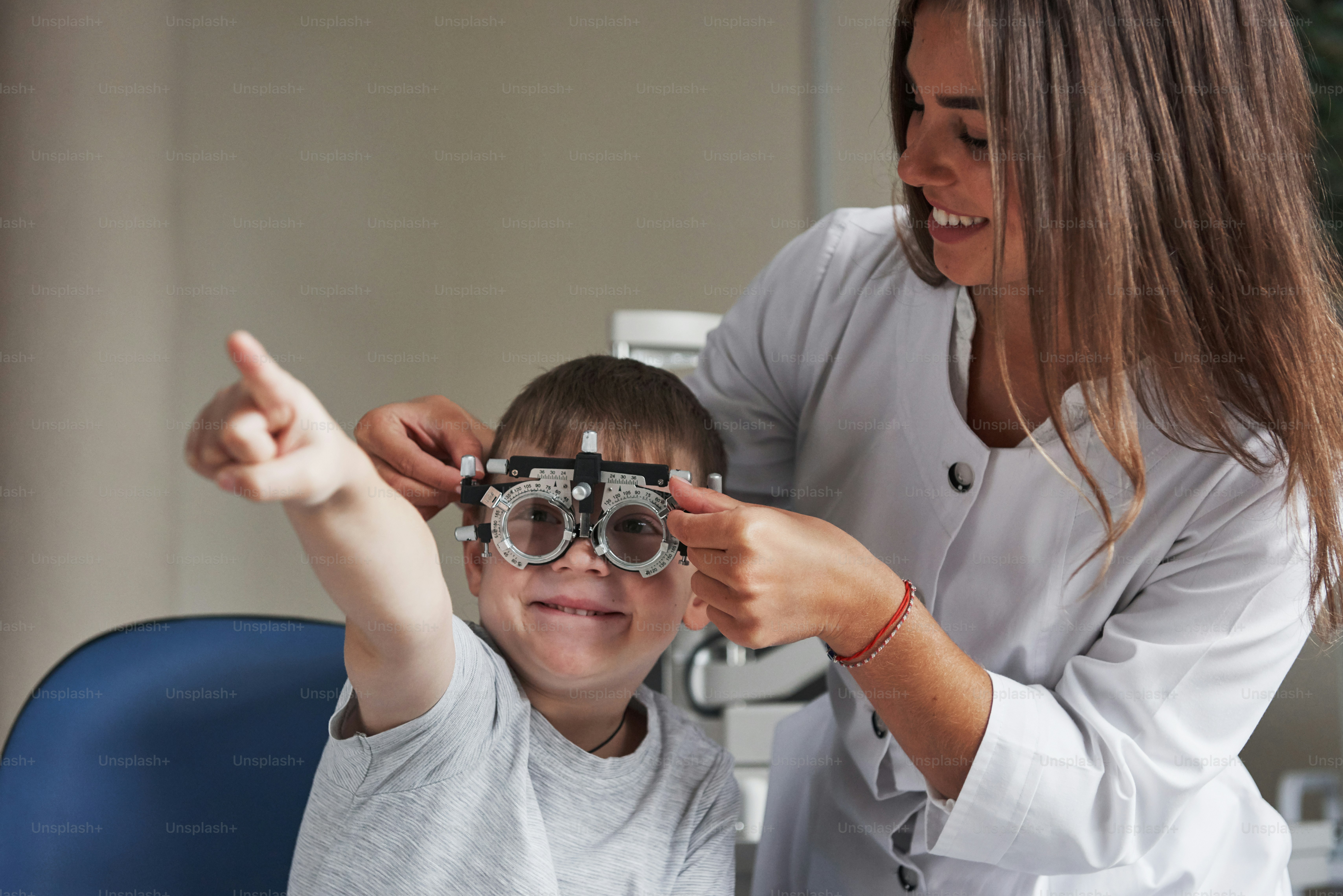 Smiling and reading. Child sitting in the doctor's cabinet and have ...