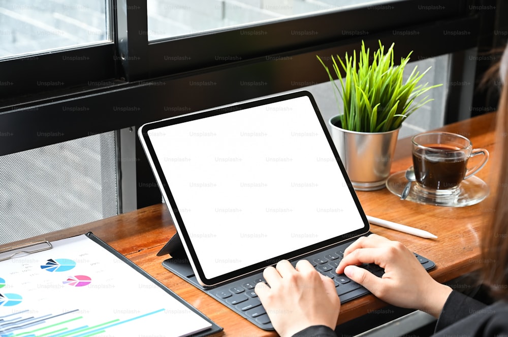 Business woman using mockup tablet with finance paper, Close up shot.