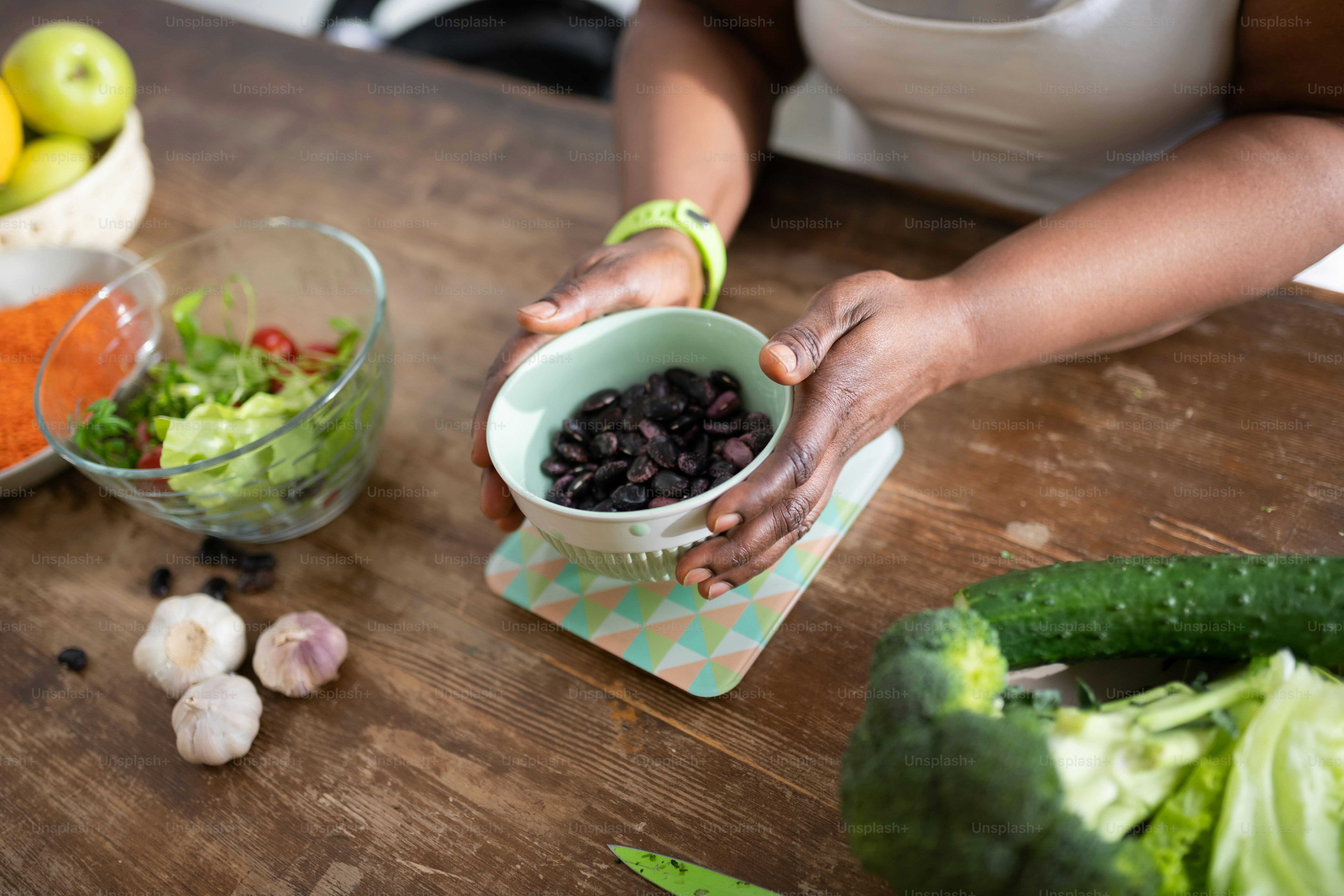 Magic beans. Close up of female hands that holding plate while measuring the weight of product