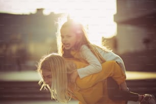Happiness is playing with your daughter. Mother and daughter in the city.