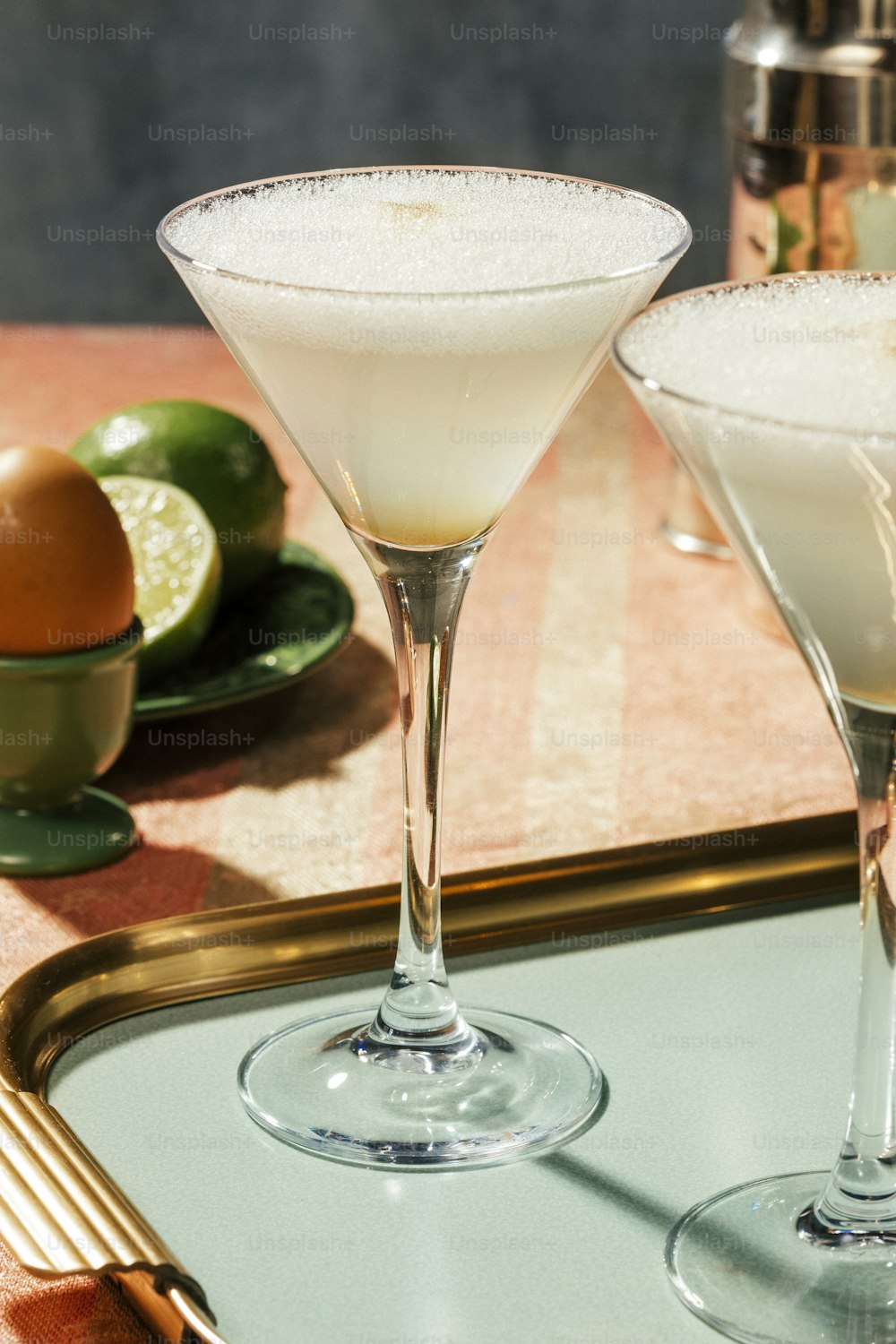 Pisco Sour, a cocktail with Pisco, lime or lemon juice, egg white, and amargo chungo or angostura, in luxury contemporary style.