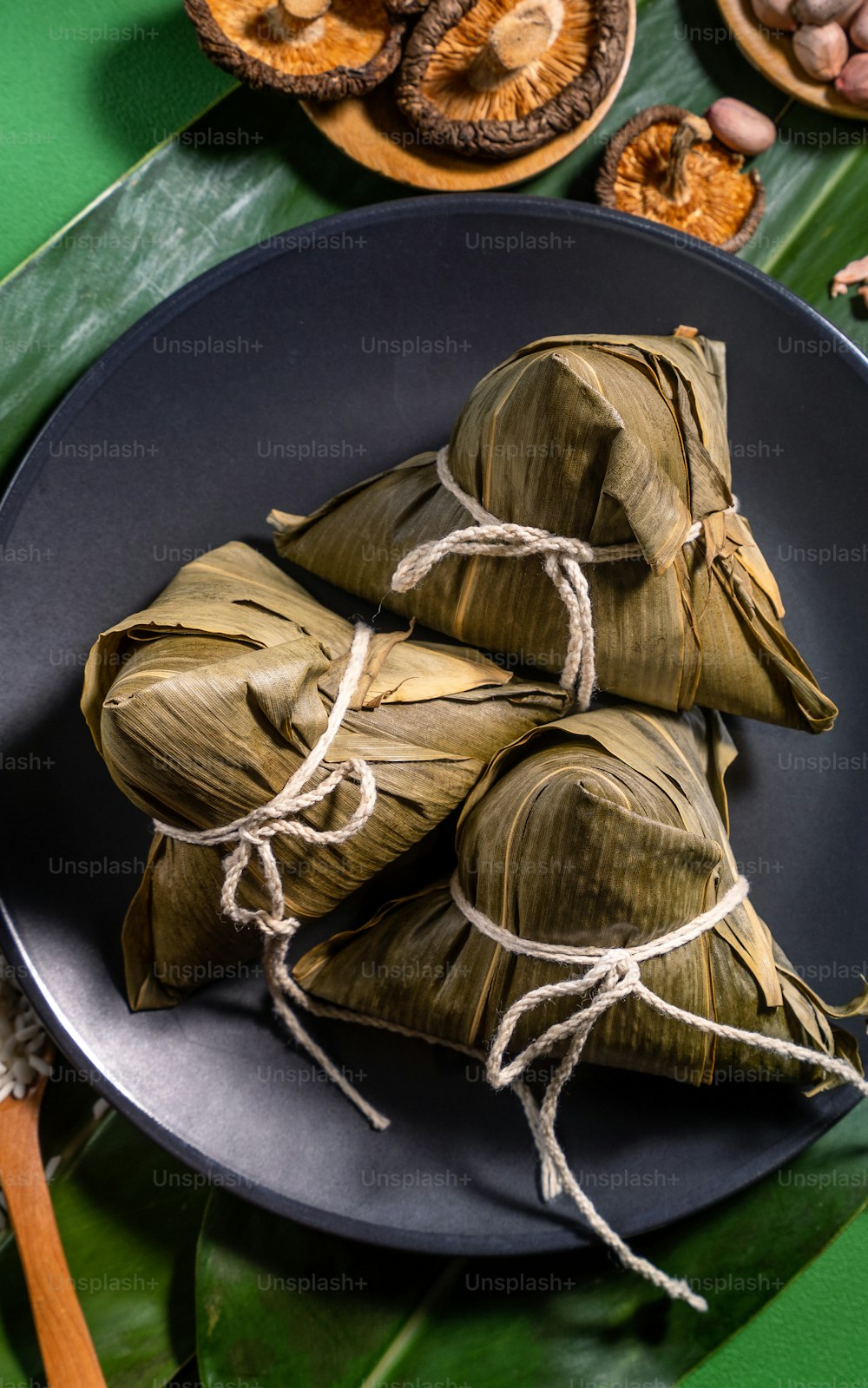 Close up, copy space, top view, flat lay. Famous asian chinese tasty handmade food in duan wu festival, steamed rice dumplings shaped like pyramidal ingredients